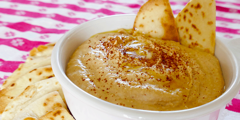homemade hummus in bowl with chips
